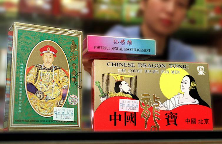 sexual enhancement drugs in packaging with Chinese characters alongside English labels