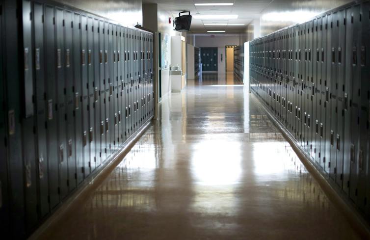 An empty school hallway lined with lockers