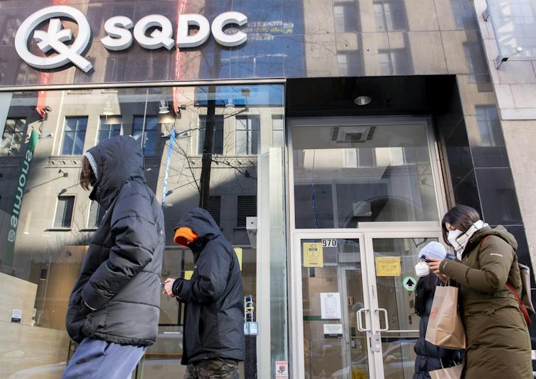 People walk by an SQDC cannabis storefront